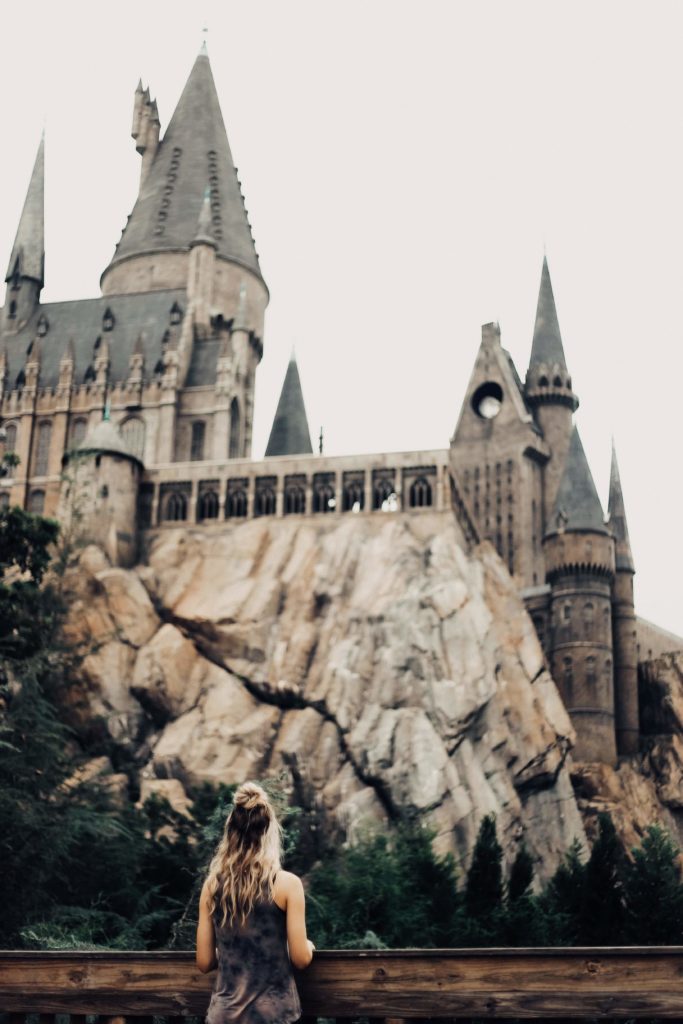 Girl looking up at Hogwarts Castle in the distance