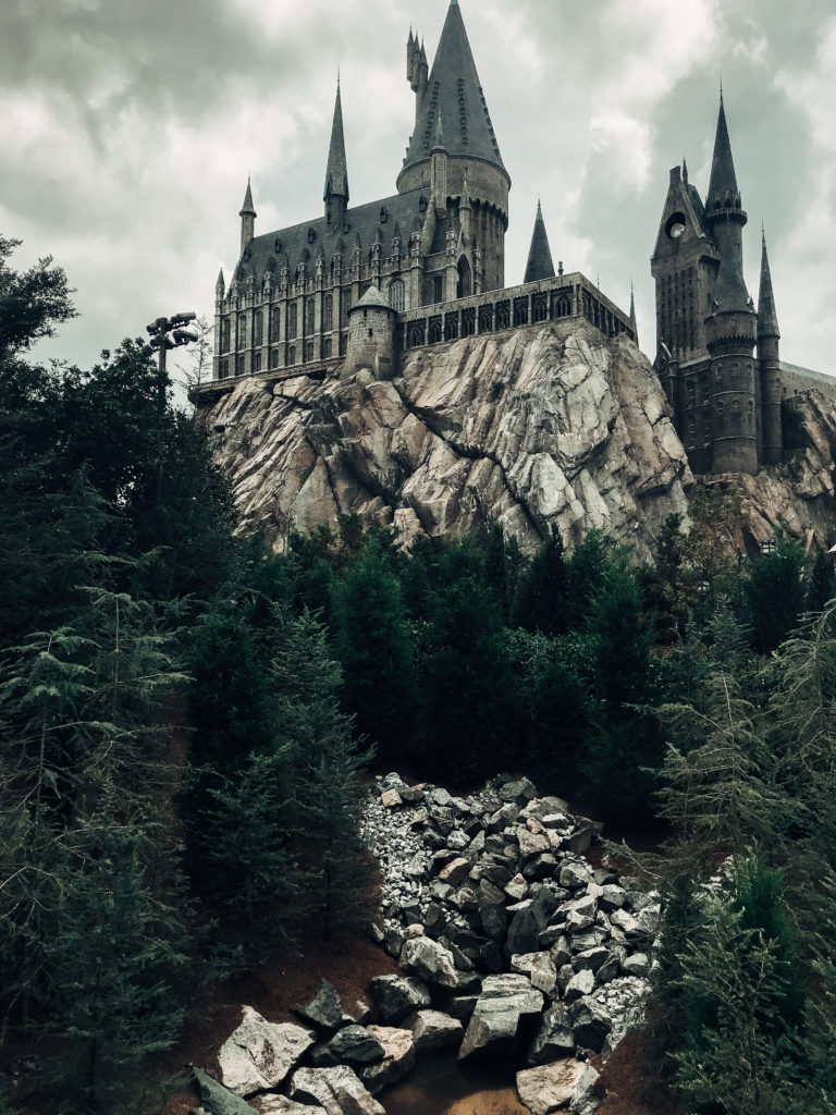 View of river leading to Hogwarts Castle with dark gray storm clouds looming overhead